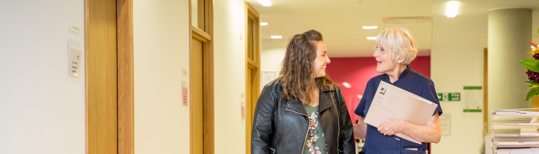 Senior sister escorting patient in outpatient department