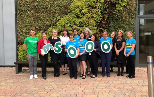 KIMS Hospital team outside the living wall celebrating raising money for macmillan