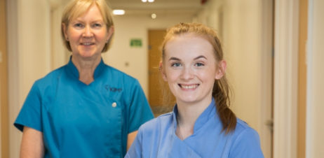 Care support worker and staff nurse at sevenoaks medical centre standing together smiling