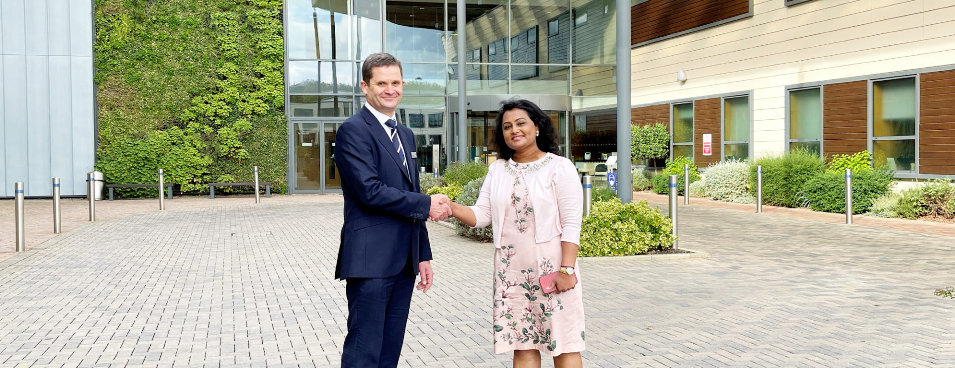 KIMS Hospital CEO, Simon James, and LycaHealth Chair, Prema Subaskaran are pictured shaking hands to celebrate the investment.