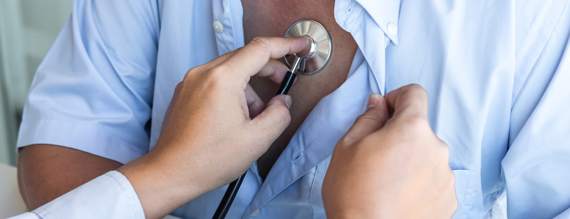 Close up of a consultant checking a patient's heart beat using a stethoscope