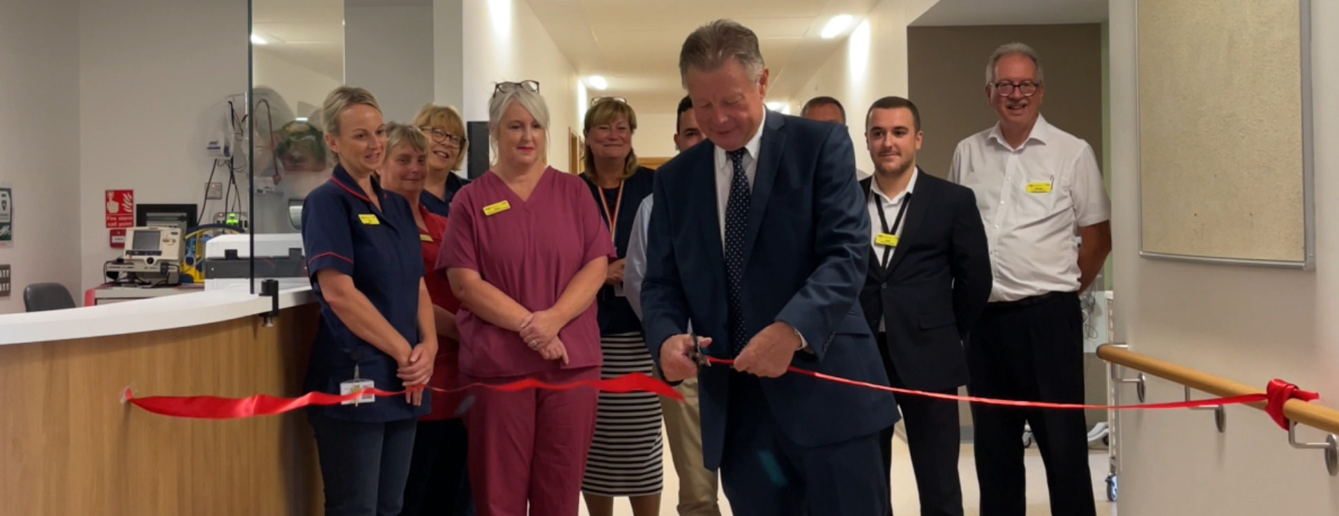 Official reopening of the wards at KIMS Hospital with a tape cutting ceremony whilst staff look on