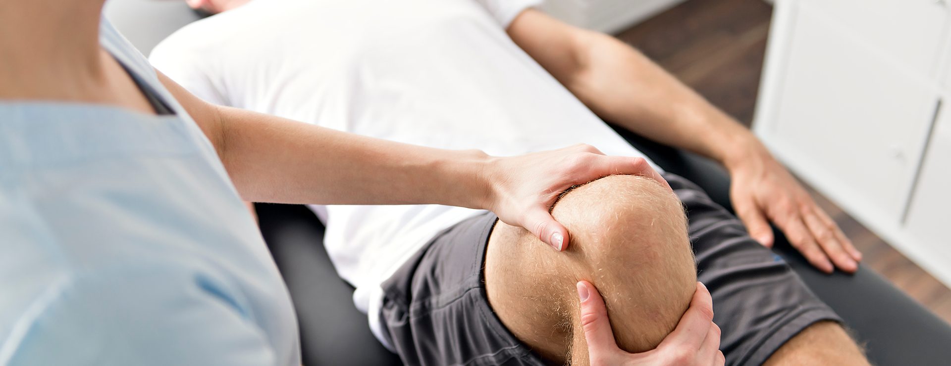 Physical therapy on a patients knee after a sporting event