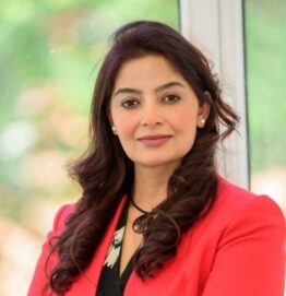 Dr Vimple Bhalani, experienced female Private GP in the UK, multilingual and passionate about holistic patient care, smiling in professional headshot.