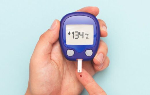 Close-up of a person using a blood glucose monitor to check blood sugar levels, highlighting the importance of early detection and awareness of Type 2 diabetes.