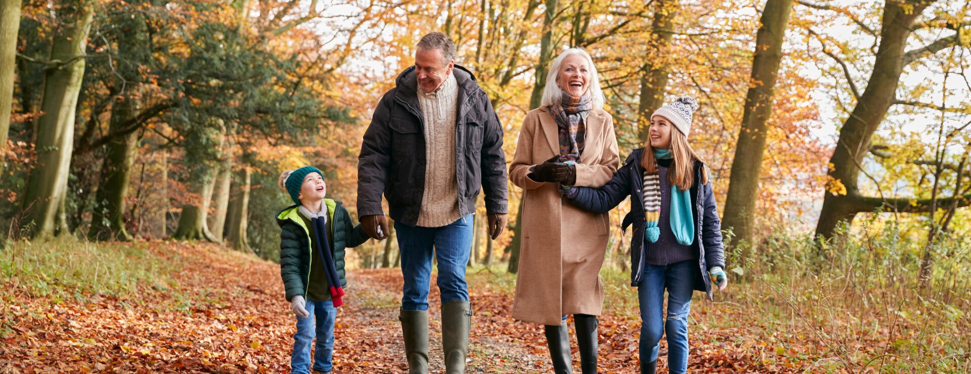 Grandparents on an autumn walk with grandchildren after orthopaedic surgery,